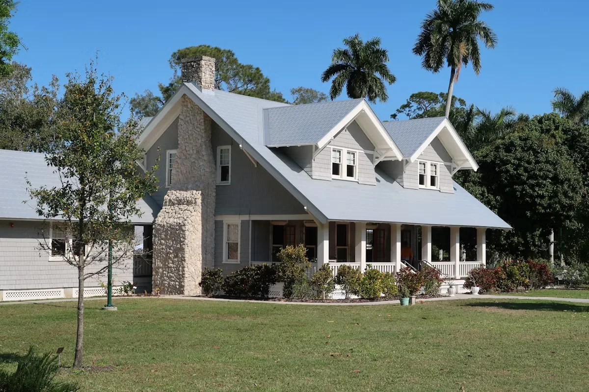 A house surrounded by an open grass field during daytime