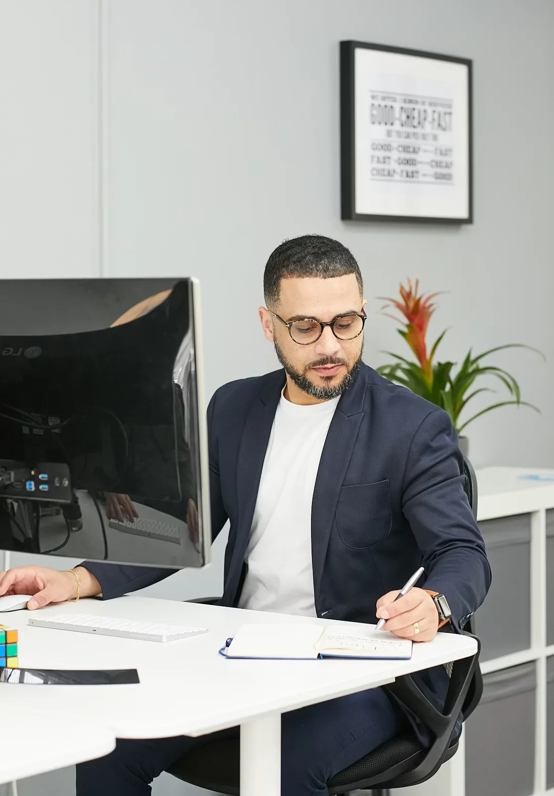 A man sitting at a desk working through paperwork